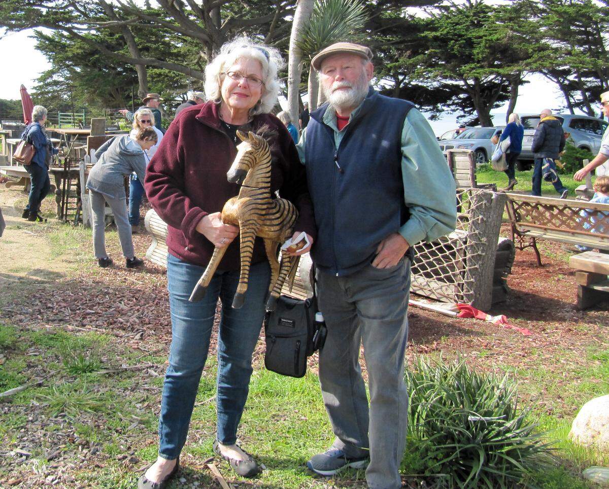 Tom Johnson and Margie Zlotowitz show off a wooden zebra they purchased at the Daou Ocean “treasure sale” Saturday. Proceeds from the sale went to Friends of the Fiscalini Ranch Preserve.
