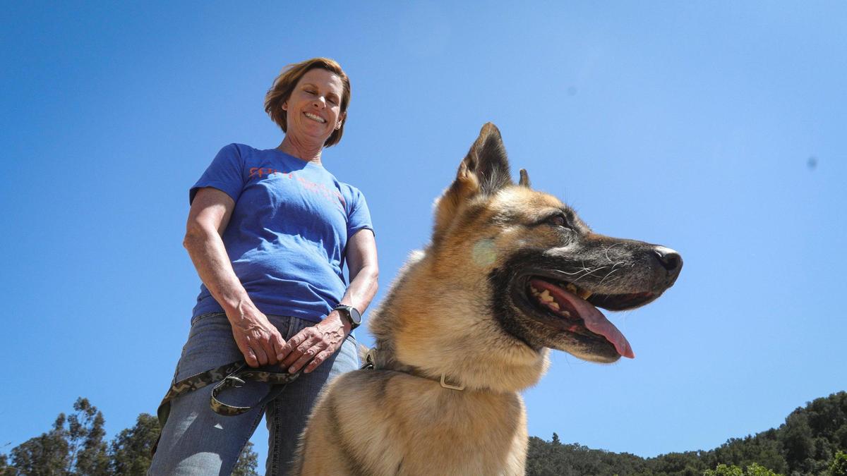 Cheryl Miller, co-owner of Springdale Pet Ranch, with German shepherd Llama.