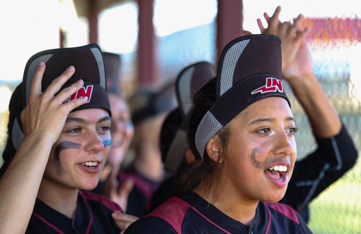 Nipomo players put on their rally caps in the dugout in the 7th inning. After trailing all game, the Nipomo Titans beat the Fallbrook Warriors 9-8 in a walk-off win in the first round of the Division V CIF Southern California Softball Championships.
