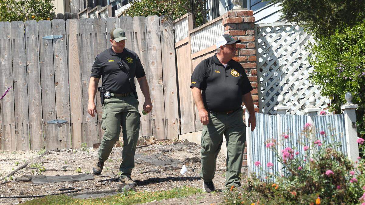 San Luis Obispo County Sheriff’s Office Cmdr. Ian Doughty and Det. Clint Cole patrol a yard west of the Susan Flores house on Branch Street. The Sheriff’s Office served a search warrant at the home on Wednesday, May 6, 2026, in connection with the Kristin Smart murder case.