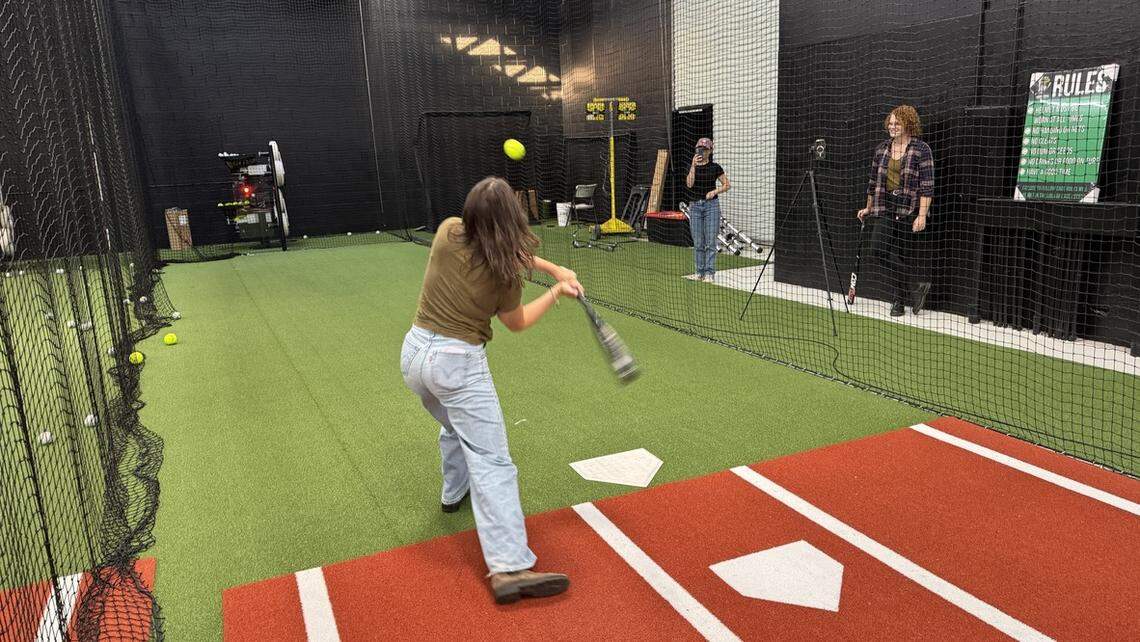 Tribune reporter Chloe Shrager takes a cut on a pitch in the batting cage at SLO Swing Sports on Oct. 10, 2025.
