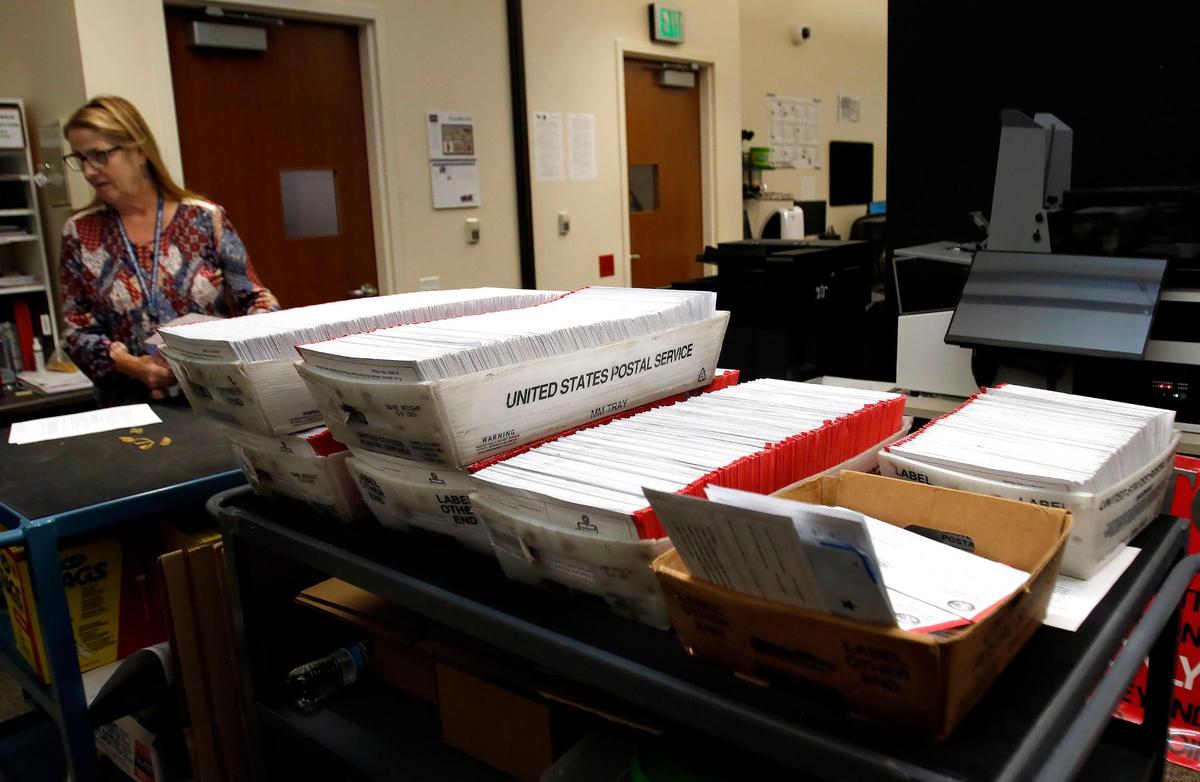 Vote-by-mail ballots await counting at the San Luis Obispo County Clerk-Recorder’s Office on Nov. 9, 2022.