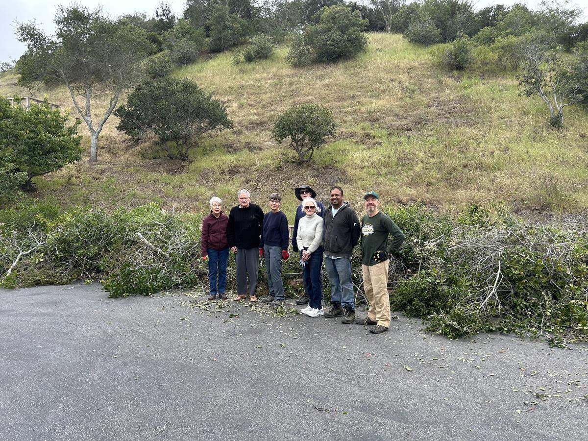 Bunea Vista Estates residents Diane Duenow (left), Daniel Pease, Donna Kalkowski, Rory Murphy, Georgina Pease, Aaskash Shaw and Dan Fake gathered for a community work day to trim vegetation on April 25, 2026.