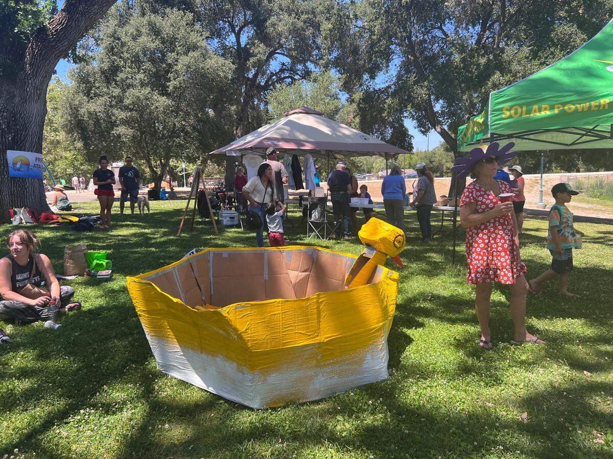 Michael Asmundson, 35, Tanner Drill, 27, and Gavin Prudence, 38, of San Luis Obispo who won the Open Class of Atascadero Lake Fest’s cardboard boat race with their rubber duck style boat.
