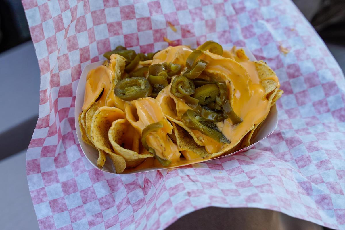 Tribune reporters Angel Corzo and Sasha Tuddenham enjoy a snack of nachos and fresh lemonade at the California Mid-State Fair on Wednesday, July 16, 2025. The Mid-State Fair will run from July 16-27.