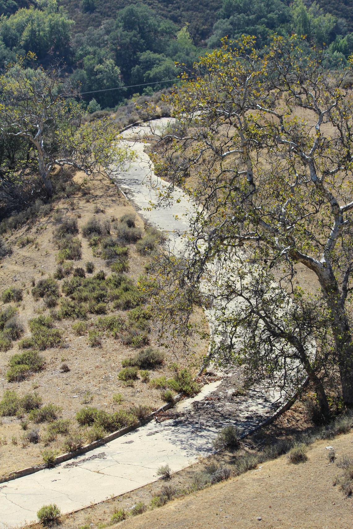 The single-lane concrete Cuesta Grade road on Highway 101 still survives in remnants. Much of the curving road was bypassed with the multi-lane highway replaced it.