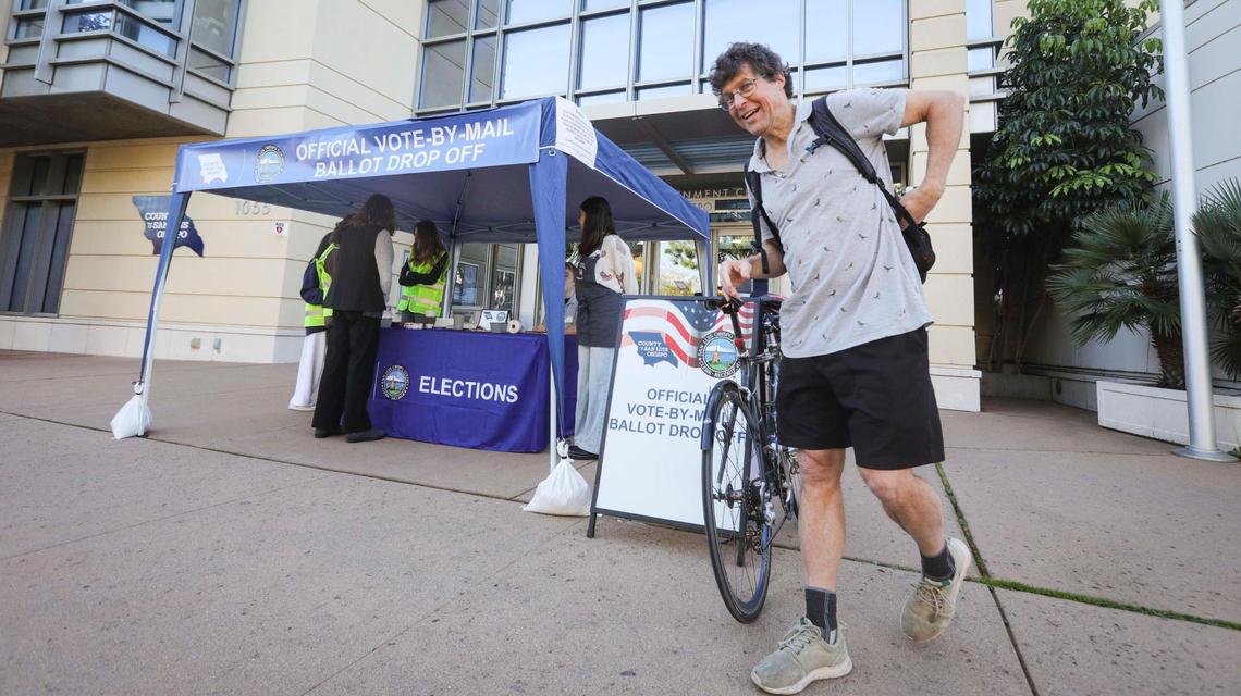 Pete Schwartz stops to drop off his ballot while bicycling on his way to the Cal Poly physics department. Ballots were being collected at the San Luis Obispo Clerk-Recorder’s office at the Katcho Achadjian Government Center during the Super Tuesday election on March 5, 2024.