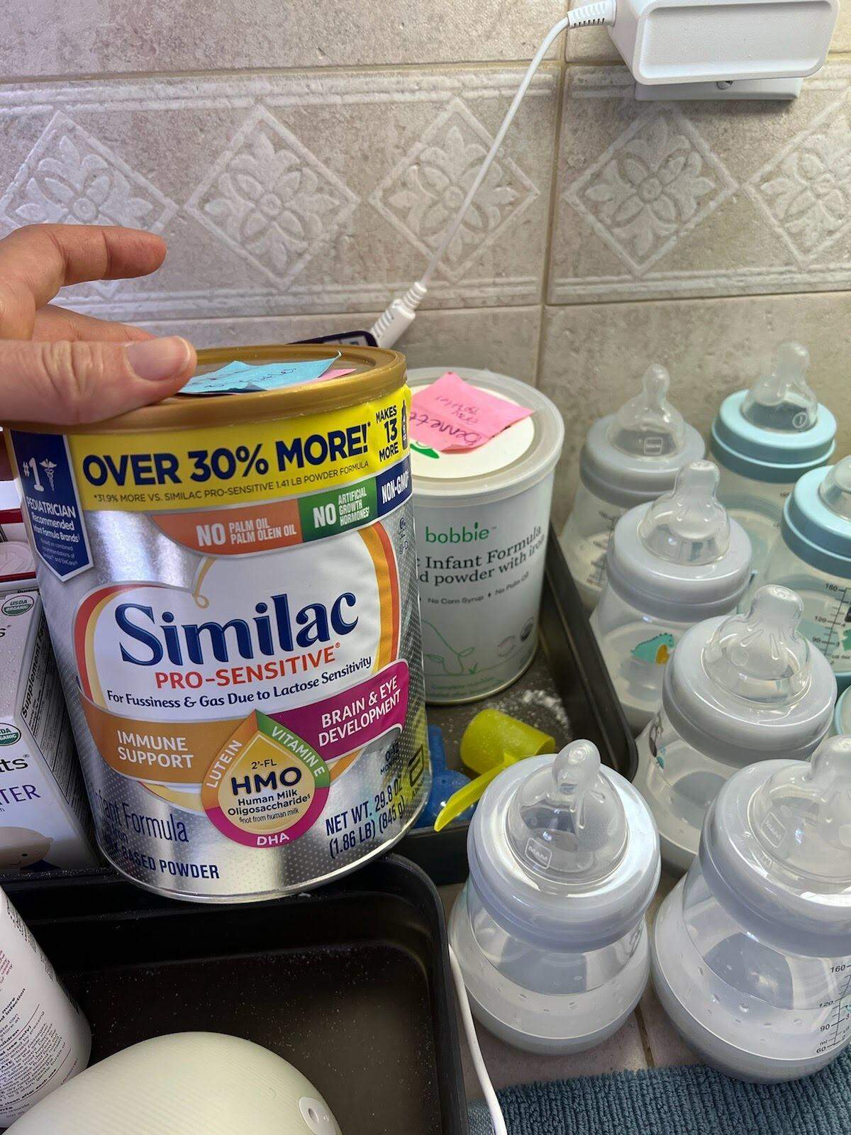 The specialty infant formula that Larkin Citrin of Shell Beach, California, needs is out of stock almost everywhere. His twin brother, Bennett, is able to eat the Bobbie formula in the back.