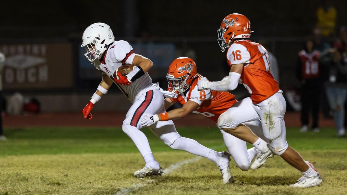 Jonathan Druding gets out ahead of Ethan Blais and Cameron Pickard in Paso Robles’ 30-15 win over Atascadero in a high school football game on Sept. 20, 2024.