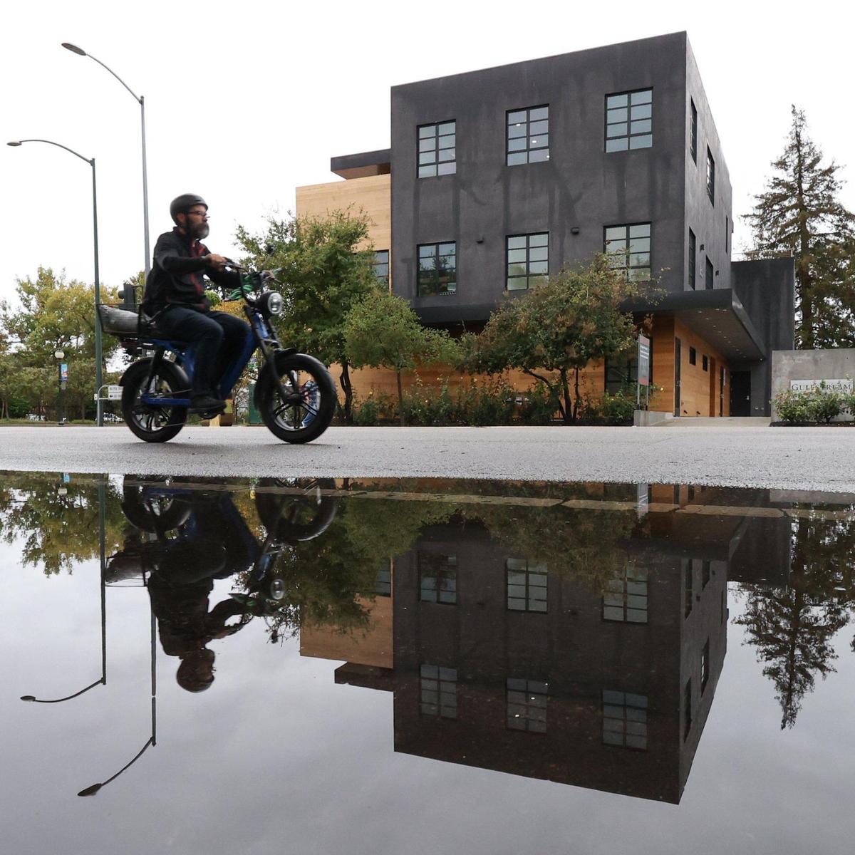 A cyclist rides past a puddle on Santa Rosa Street in San Luis Obispo on Monday, Sept. 19, 2022. An early-season rainstorm dropped as much as 1.5 inches of rain in parts of San Luis Obispo County.