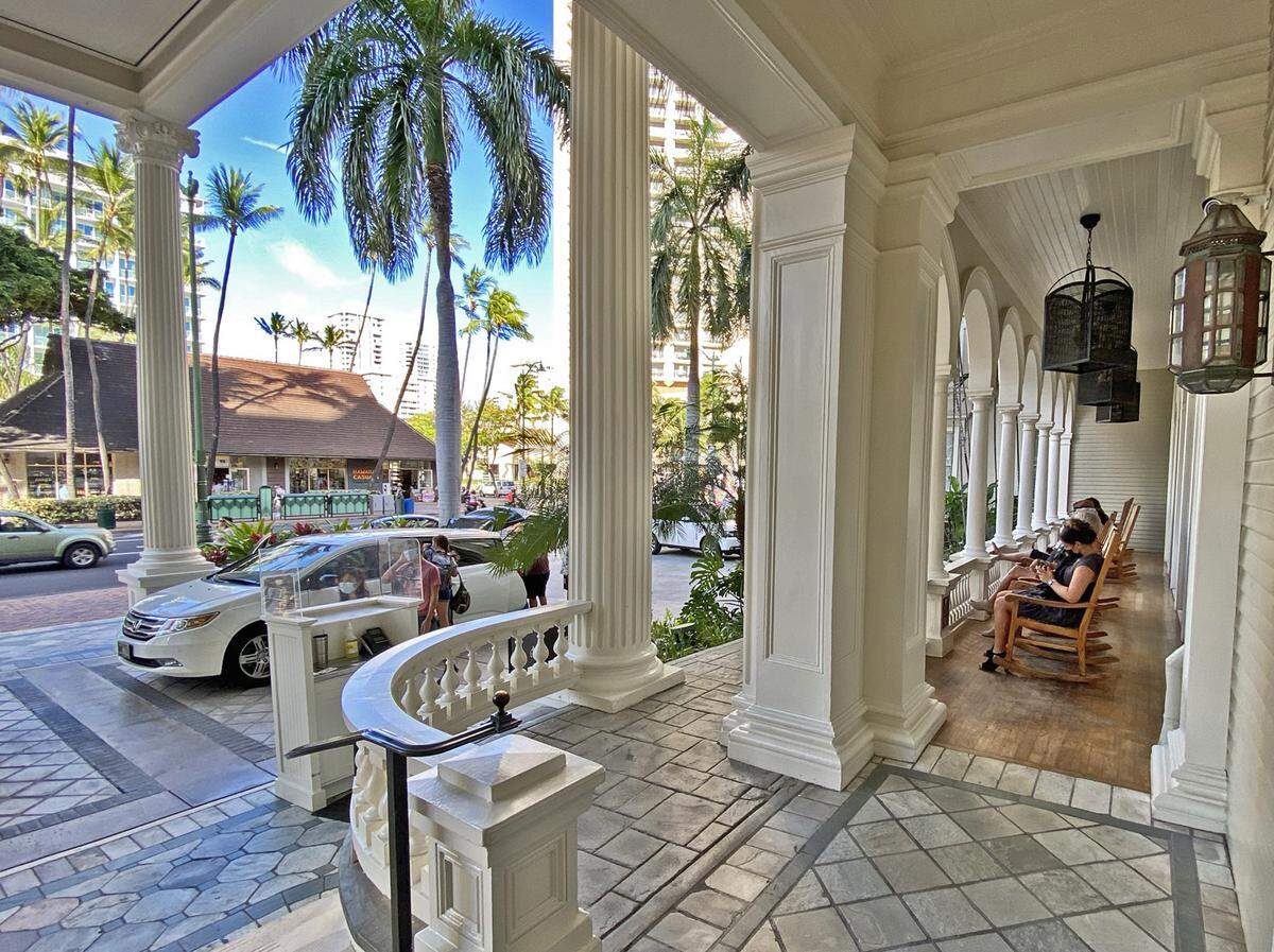 Rocking chairs on the porch of the Moana Surfrider hotel in Honolulu, Hawaii, offer prime Waikiki Beach people watching.