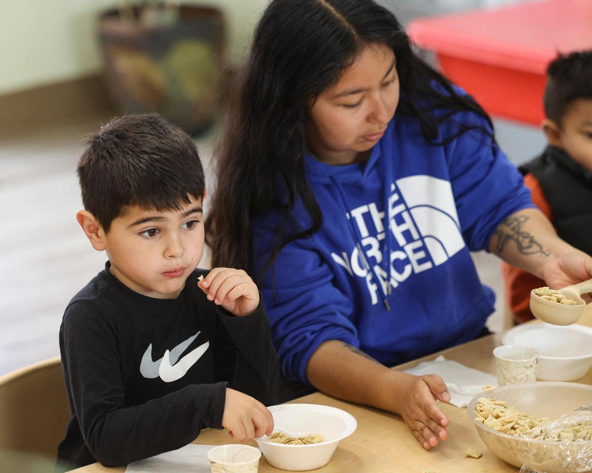 Benjamon Arroyo has breakdast, Chantelle Vargas, associate teacher serves at the table group during activities at CAPSLO’s Head Start program in Nipomo on April 25, 2025.