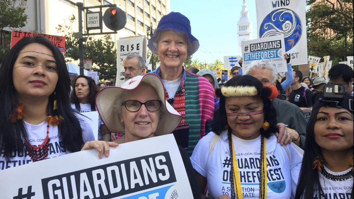 Sheral Marshall, center left, and her care provider Maureen Sinnott attend a climate change demonstration in San Francisco. The two women are both Franciscan nuns who advocate for people living with Alzheimer’s Disease.