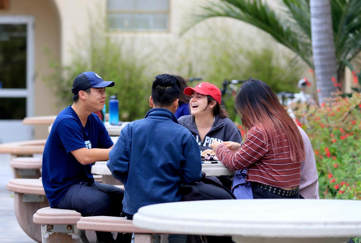 Cal Poly students chat during a break between classes.