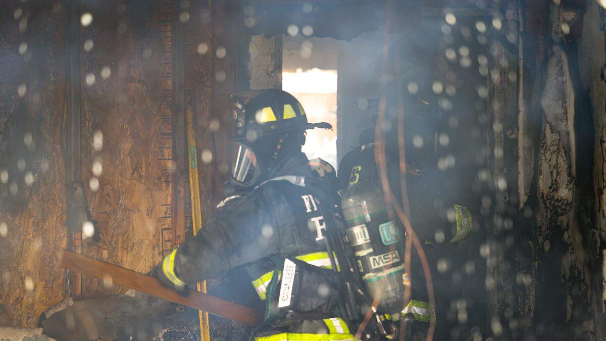 A firefighter battles a two-alarm blaze that damaged two floors of a home on the 1500 block of 22nd Street in Oceano on Monday, Feb 27, 2023. Five Cities Authority, Cal Fire and the Santa Maria Fire Department were among the agencies that responded to the scene.