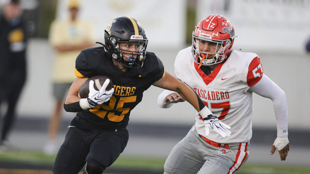 JakeRyan Crocker runs pursued by Zekaryah Legaspi.  San Luis Obispo beat Atascadero 38-14 on Sept. 11, 2026.