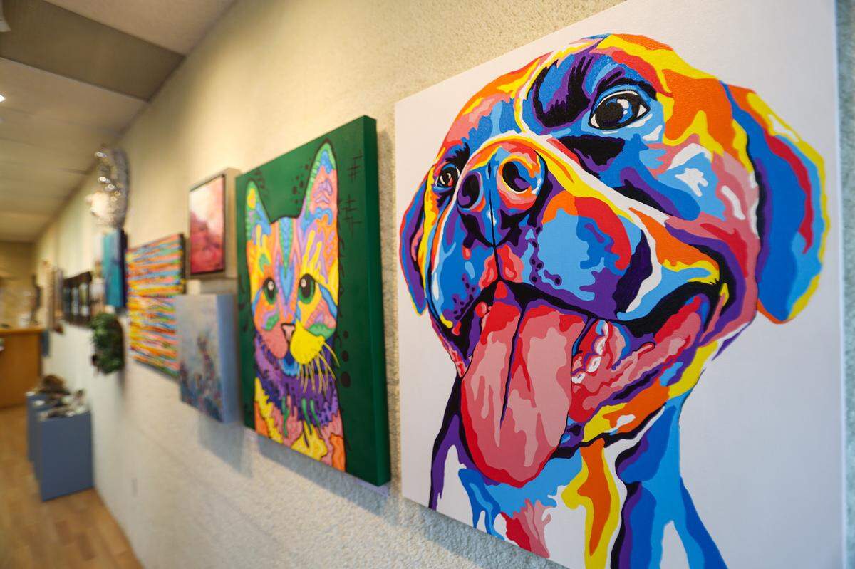 The Morro Bay Art Association is holding its Winter Faire and Craft Show at the Art Center Morro Bay. Rhys Manning painted the rainbow paintings in the foreground.