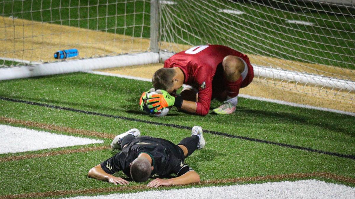 Cal Poly keeper Gabe Penner and #17 Nate Colley react to the shot that put UCSB ahead with 12 seconds in regulation. Cal Poly fell to UCSB 2-1.