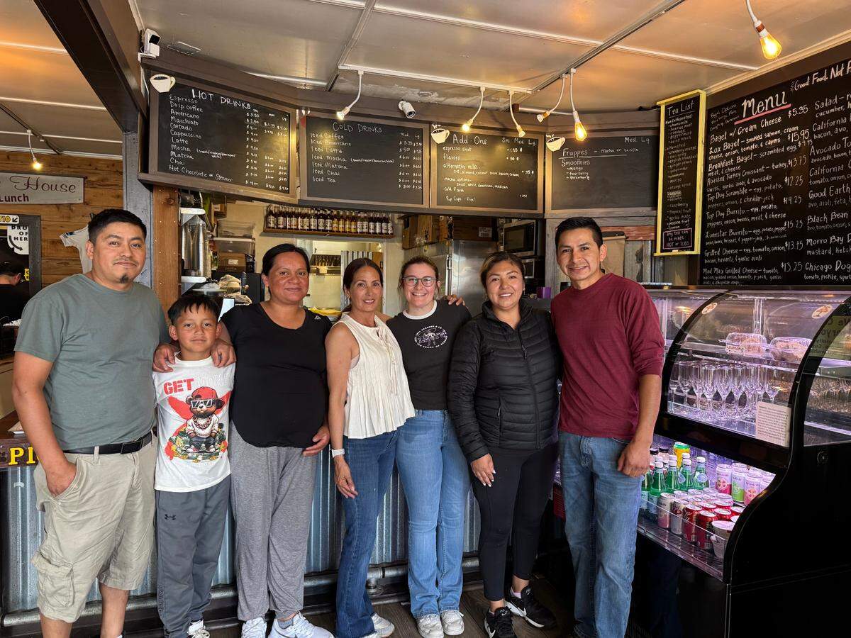 Top Dog Cafe Bar opened at 857 Main St. in Morro Bay on May 26, 2025. Owners and employees pose for a photo in the family-run cafe on July 1, 2025.