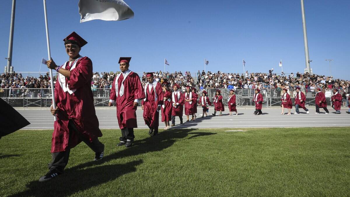 Jose Lopez caries a flag at the head of a line of graduates. Nipomo High School issued diplomas to 198 graduates on June 5, 2026.