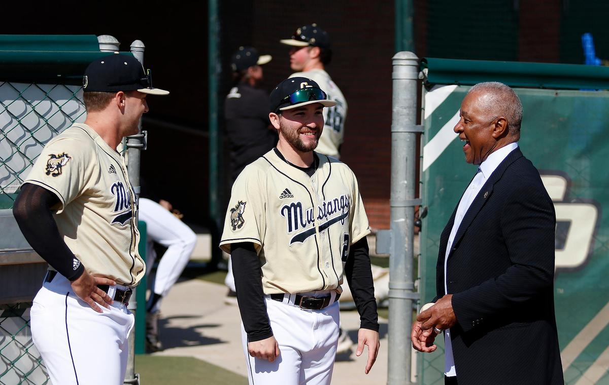 Ozzie Smith talks with Cal Poly baseball players after the re-dedication of his statue and plaza at Baggett Stadium in San Luis Obispo on March 25, 2023.