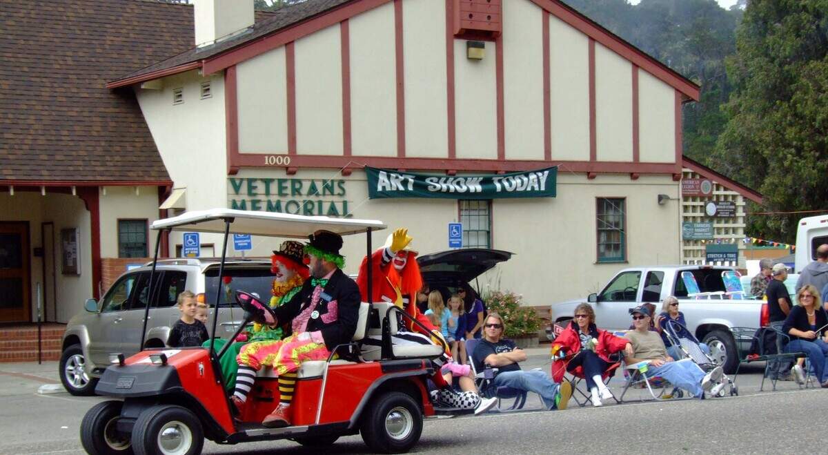 People relax in front of the Cambria Veterans Memorial Building as they watch Shriner’s clowns motor past during the 2008 Pinedorado parade. The hall has been a primary community-hall hub for the small coastal town’s residents and visitors.