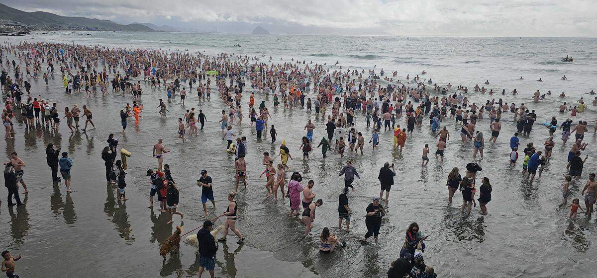 Thousands of divers braved the cold waters of the Pacific Ocean during the annual Carlin Soulé Memorial Polar Bear Dip on Thursday, Jan. 1, 2026. The 46th annual dip drew thousands of divers even amid overcast and rainy weather.