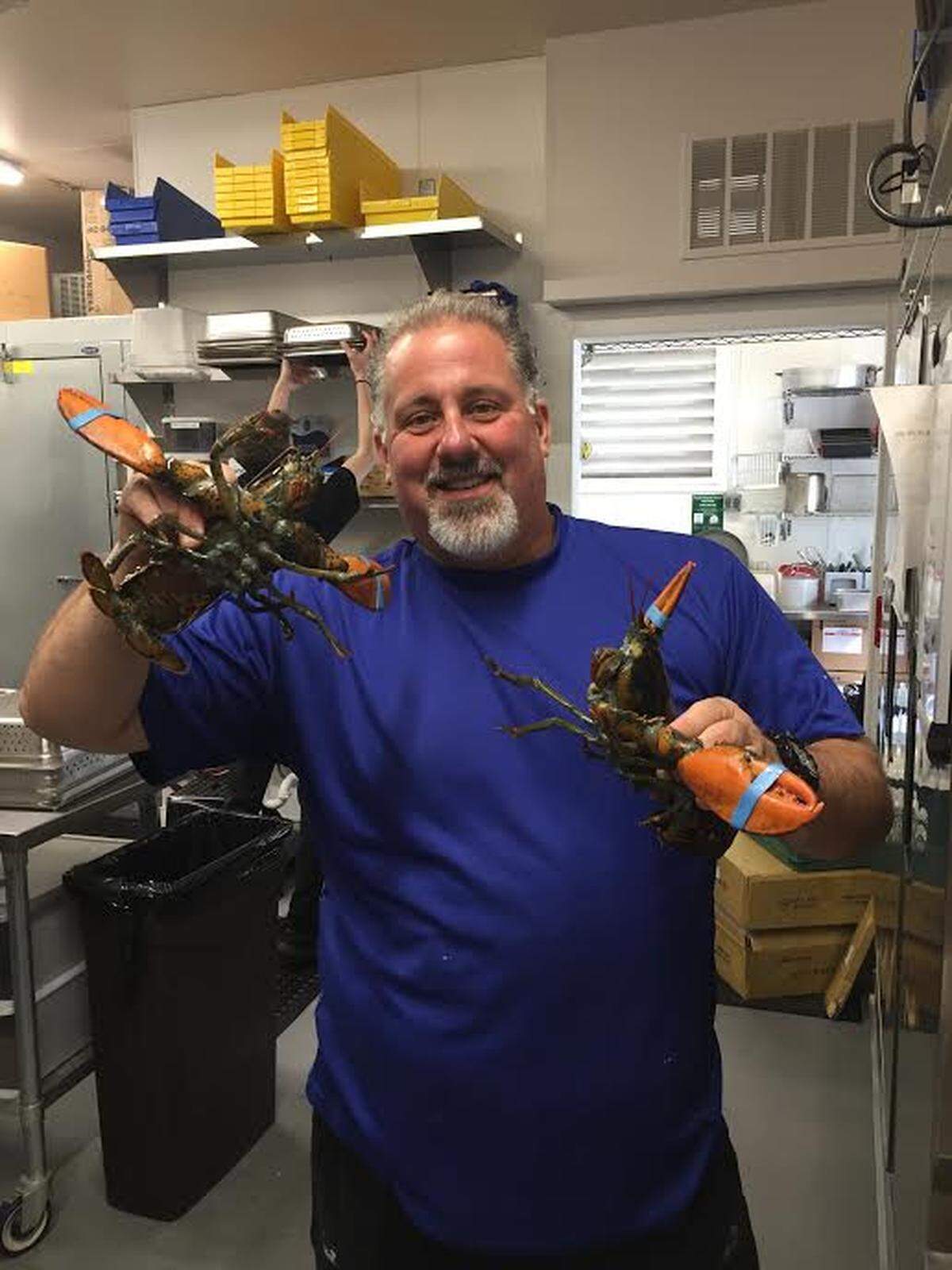 Co-owner and executive chef Douglas MacMillan poses for a picture with a live lobster at Ada’s Fish House in Pismo Beach. The seafood restaurant opened in early July 2019.