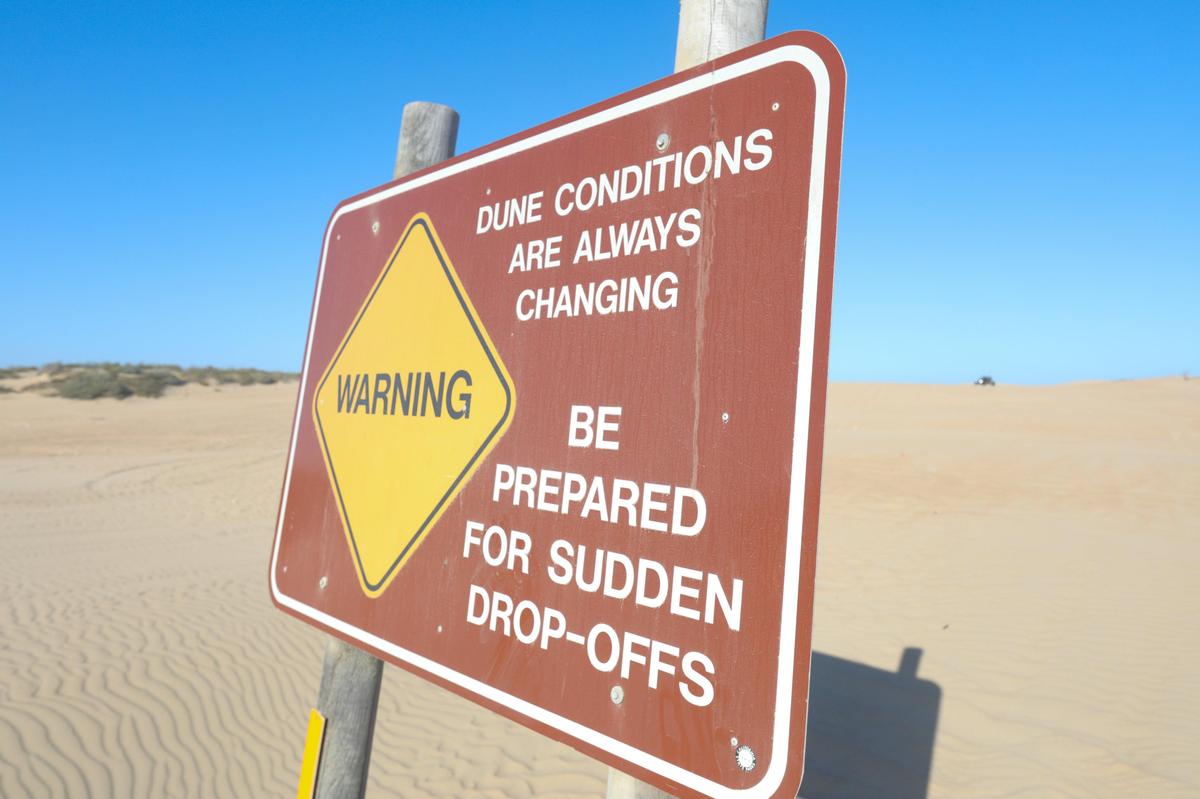 Signs warn riders about changing dune conditions at Oceano Dunes State Vehicular Recreation Area near Pismo Beach.