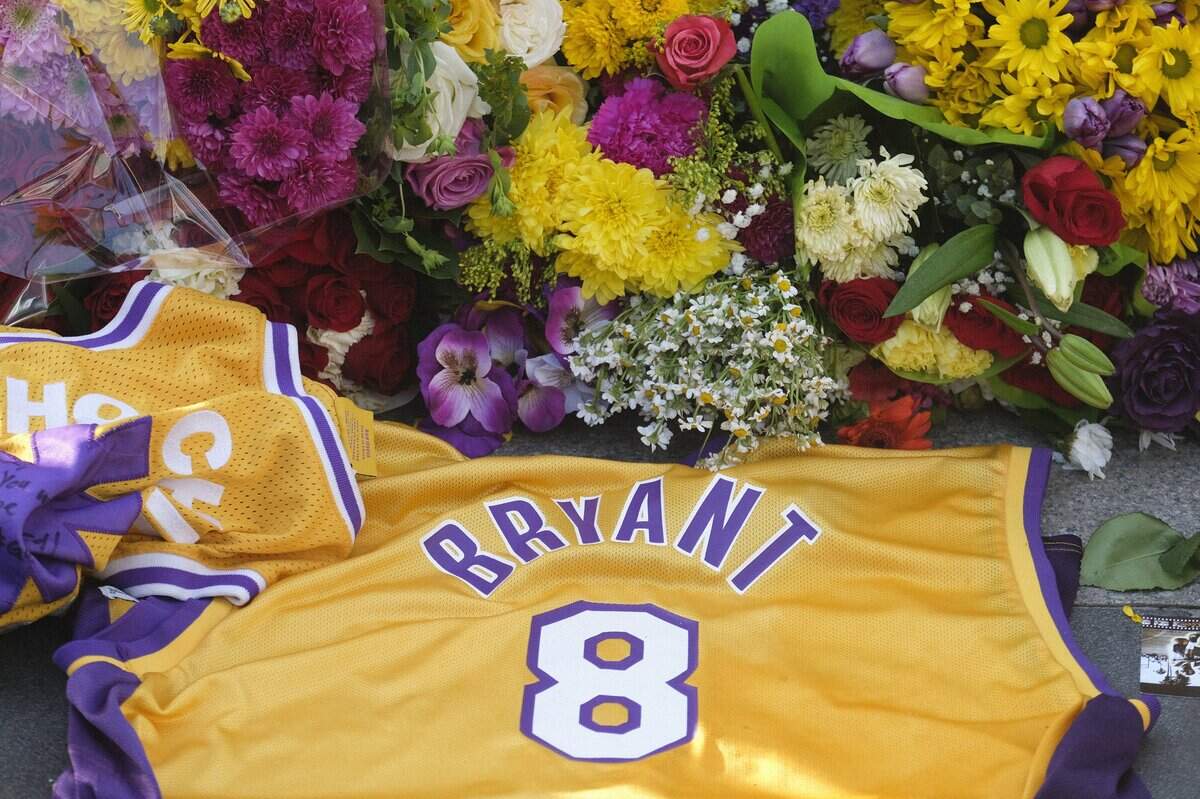 Flowers and Kobe Bryant memorabilia fill an impromptu memorial display near Staples Center on Monday, Jan. 27, 2020, in Los Angeles.