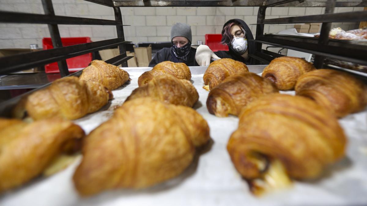 Carolyn Hinson, left and Talia Lithwin gather pastries for orders. Back Porch Bakery is offering free bread, pastries and baking supplies out of its San Luis Obispo home on Prado Road during the coronavirus epidemic. To help keep the lights on, the bakery is asking for donations from the public -- though those donations are not required. David Middlecamp 3-27-2020