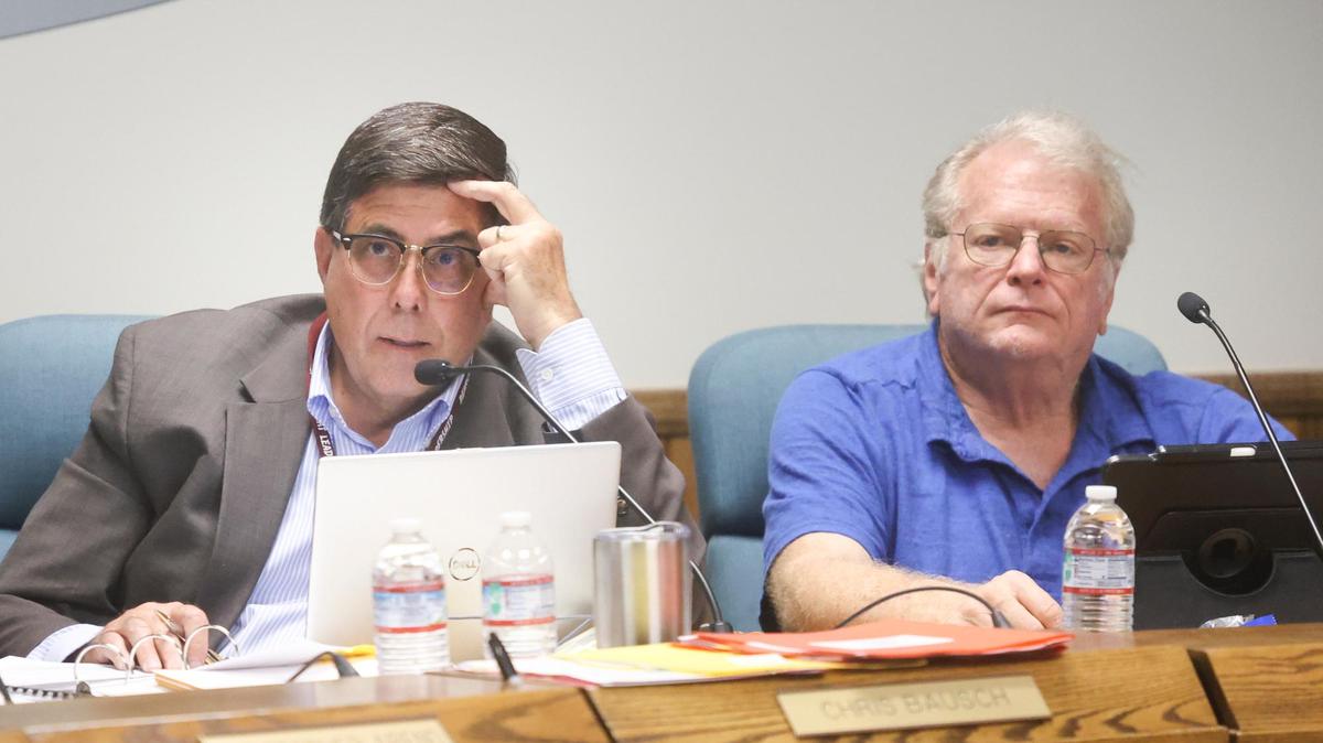 Paso Robles schools trustee Chris Bausch asks a question while trustee Jim Reed listens at right. The Paso Robles Joint Unified School District board heard public comment on a resolution to ban teaching of critical race theory at it schools during a meeting on June 22, 2021.