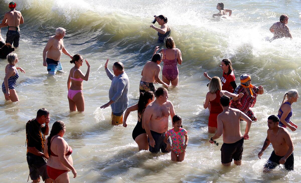 Hundreds of brave participants braved water temperatures in the low 50s to welcome the new year near Cayucos Pier.