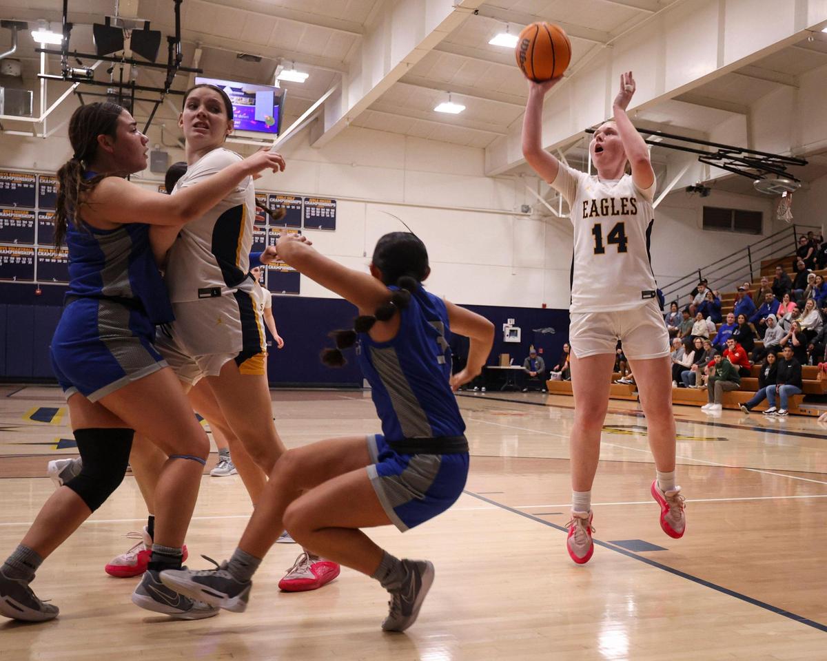 Ellie Sloan shoots behind a screen from Diana Sorrondo as Arroyo Grande fell to Caruthers 51-36 in a high school girls basketball playoff on Feb. 14, 2024.