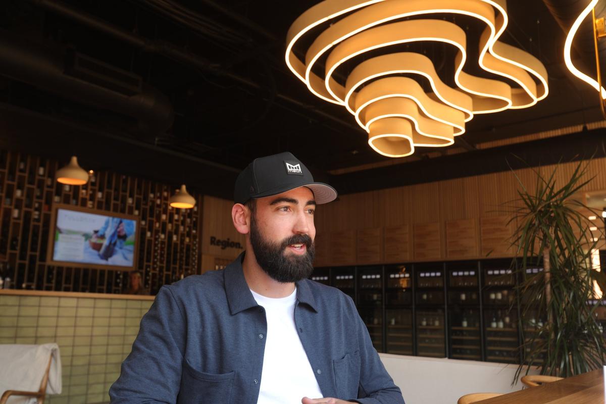 John Eide is owner of Region, a wine tasting room that represents over 25 county wineries April 29, 2022. They sell by the sip, half and full glass and have information on the wineries represented.