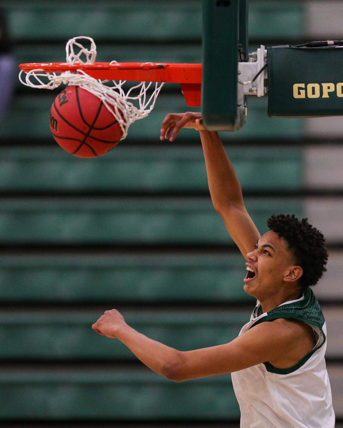 Kobe Sanders finishes a dunk Kobe en ruote to scoring 16 points in the Cal Poly basketball team’s win over beat Bethesda 100-46 on Nov. 27, 2020. Fans were absent from the bleachers due to coronavirus restrictions.