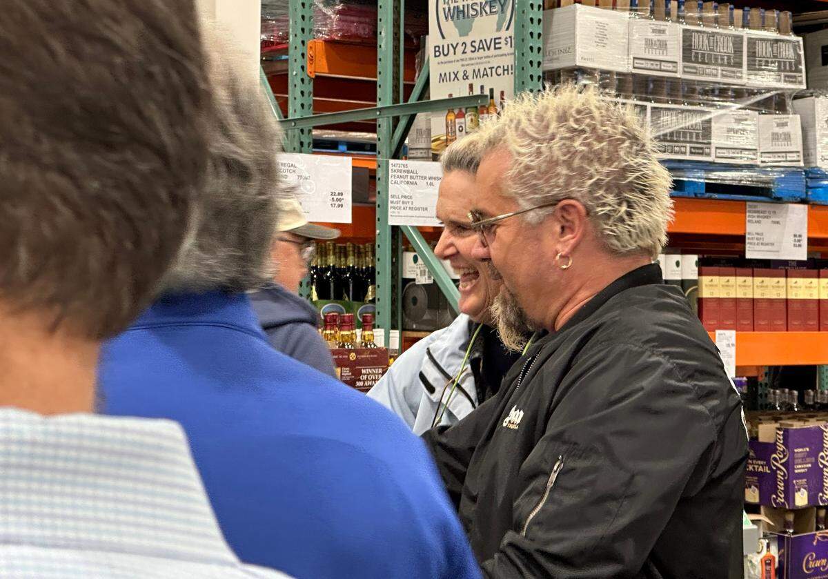 Celebrity Chef Guy Fieri signs tequila bottles at Costco in San Luis Obispo on March 6, 2024.