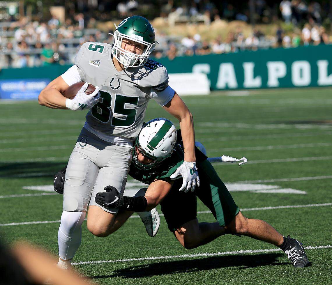 Mustang tight end Kristian Ingman fends off a Viking player. Cal Poly fell to Portland State 40-35 in a college football game at Mustang Memorial Field on Nov. 1, 2025.