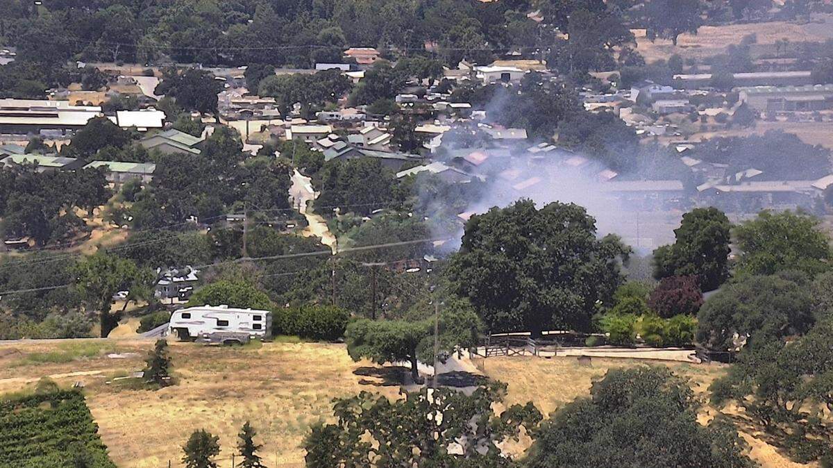 A fire burns at a home at Pina Selva Place in Templeton on Thursday, July 6, 2023.