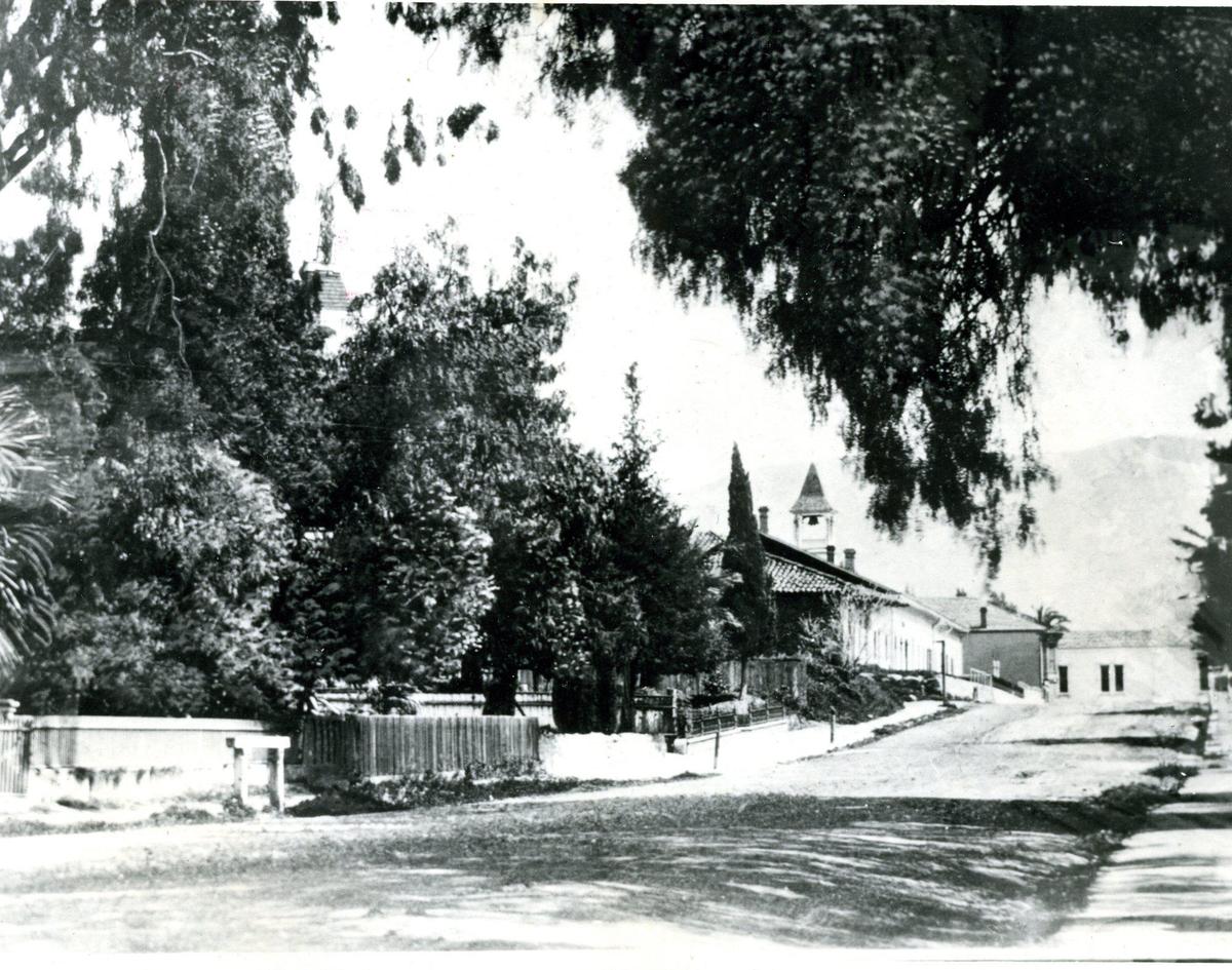 This view down Monterey Street is before the Carnegie Library was built in 1905 and shows the area around the Mission crowded with commercial buildings and the New England bell tower.