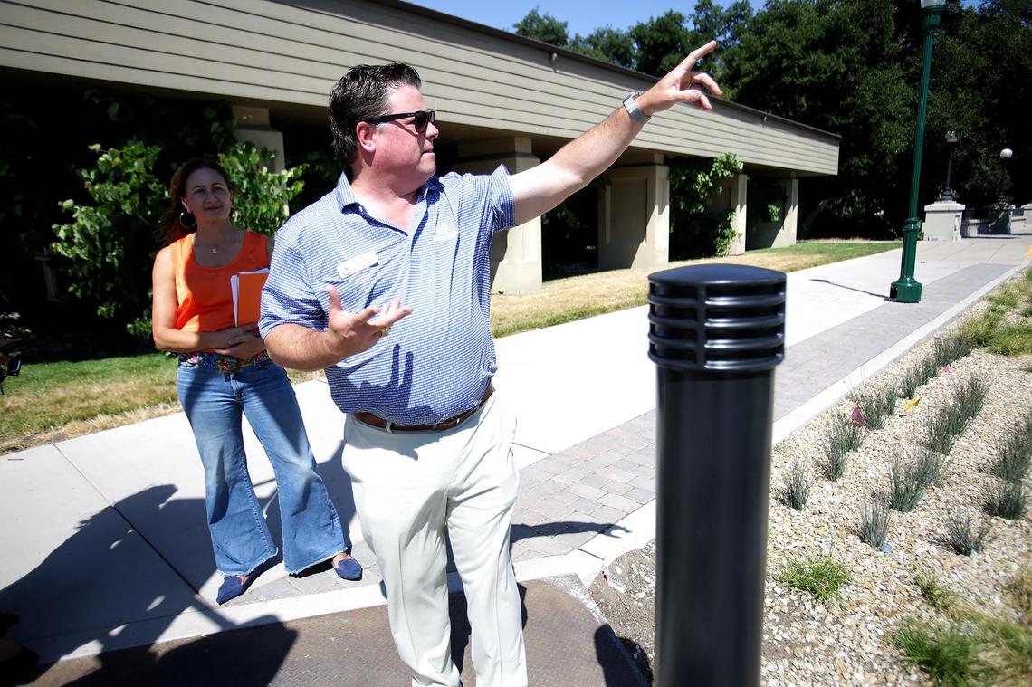 Atascadero city manager Jim Lewis points toward some of the new renovations along El Camino Real on June 27, 2025. Loreli Cappel, deputy director of economic & community development, listens in.