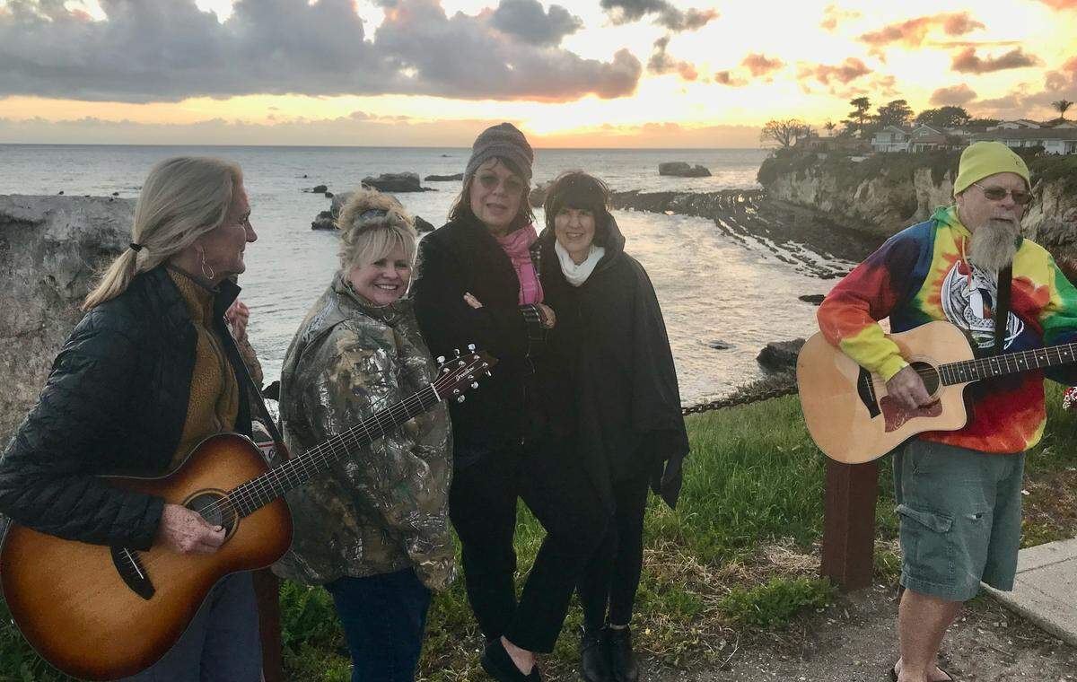 Denise Smart, center, with the JamFam at the Margo Dodd Park bench in Shell Beach.