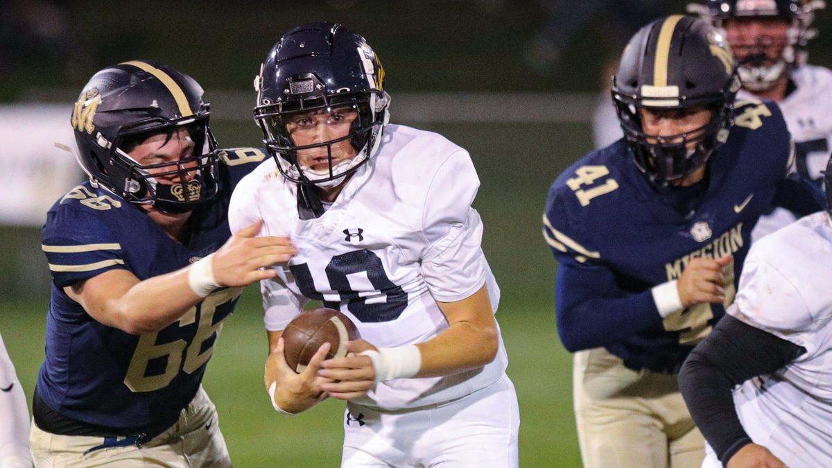 Quarterback Drake Missamore is pressured by Gabriel Ahumada and Lukas Elmerick. Mission Prep beat Arroyo Grande 41-35 in a Mountain League football game on Oct. 14, 2022.