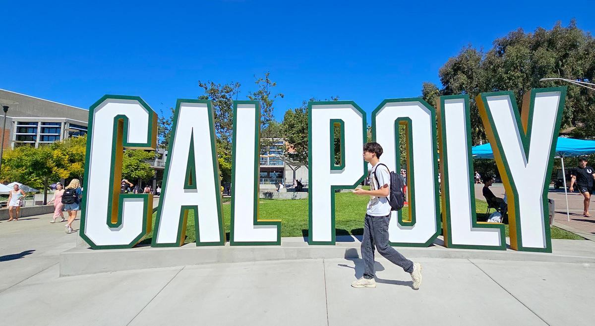 Students walk past the Cal Poly sign in the University Union on Sept. 24, 2024.