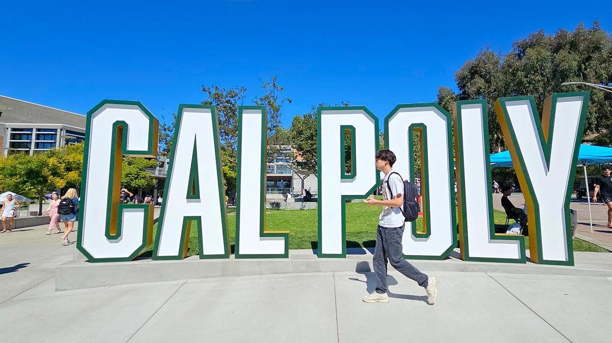 Students walk past the Cal Poly sign in the University Union on Sept. 24, 2024.