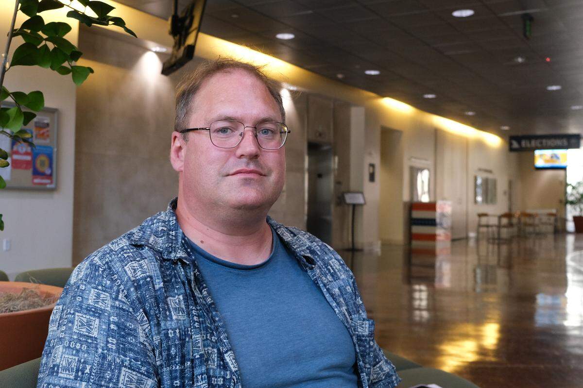 Steve Kingan, who works at Growing Grounds as a sales representative, sits outside the San Luis Obispo County Board of Supervisors chambers after speaking during public comment on May 20, 2025. Growing Grounds is a vocational work program run by Transitions-Mental Health Association to help people with severe mental illness and substance abuse disorder reenter the workforce.&nbsp;