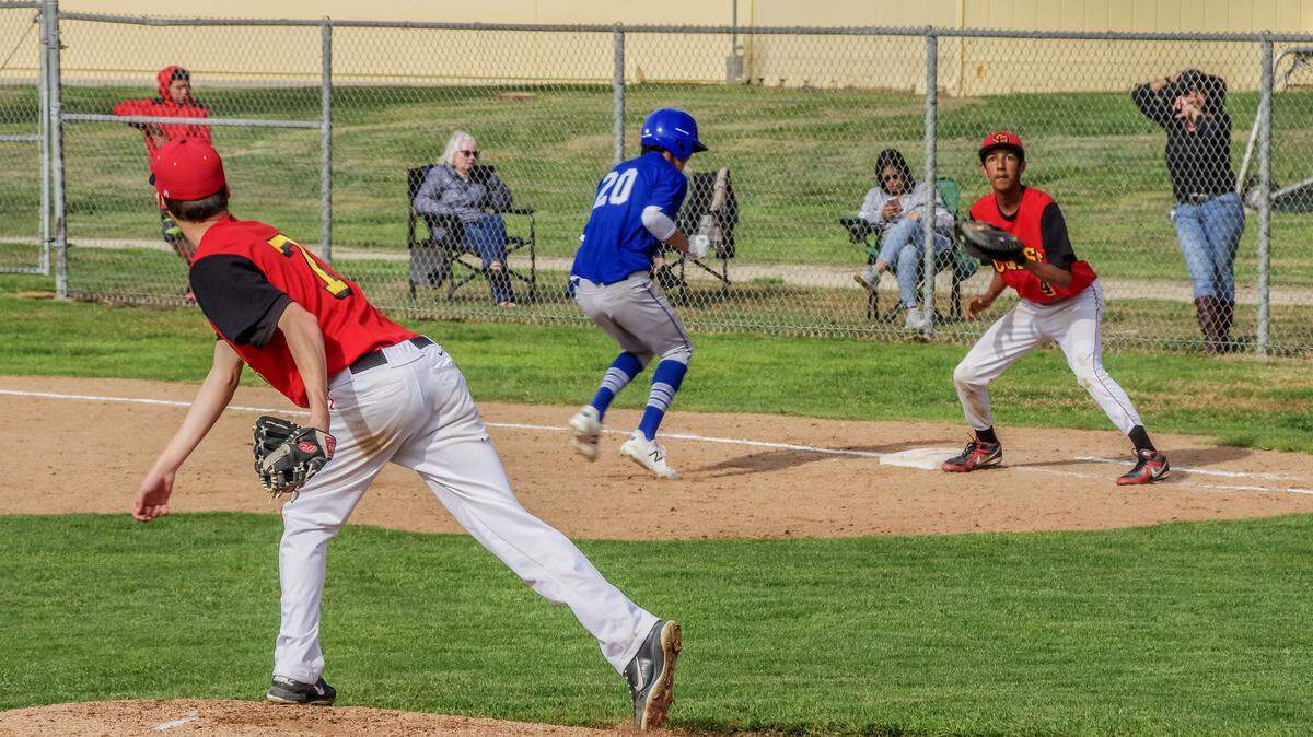 Coast Union senior pitcher Chase Volz throws to Cristian Castillo at first base on Friday, March 30 to keep a King City runner close to the bag. King City won 5-1.