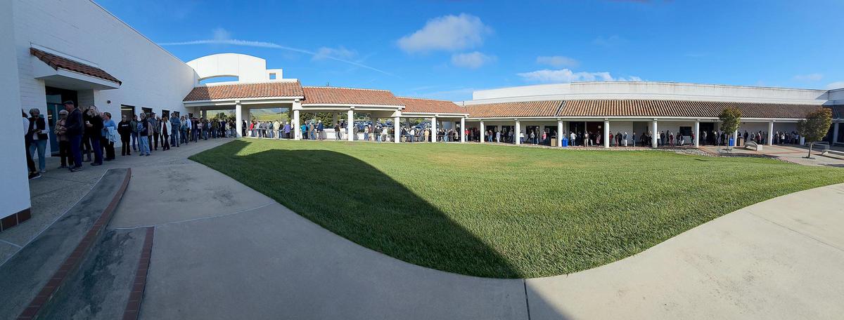 A long line of people wait to get into the Performing Arts Center at Cuesta College to hear Sen. Adam Schiff and Congressman Salud Carbajal, who held a town hall in San Luis Obispo on Tuesday, April 22, 2025.