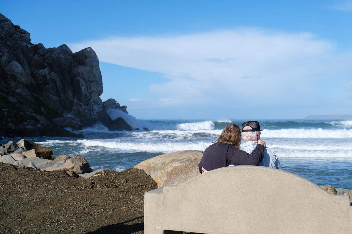 Carol, left, and her husband, Zeno, watch waves at Morro Rock in Morro Bay on Jan. 3, 2024.