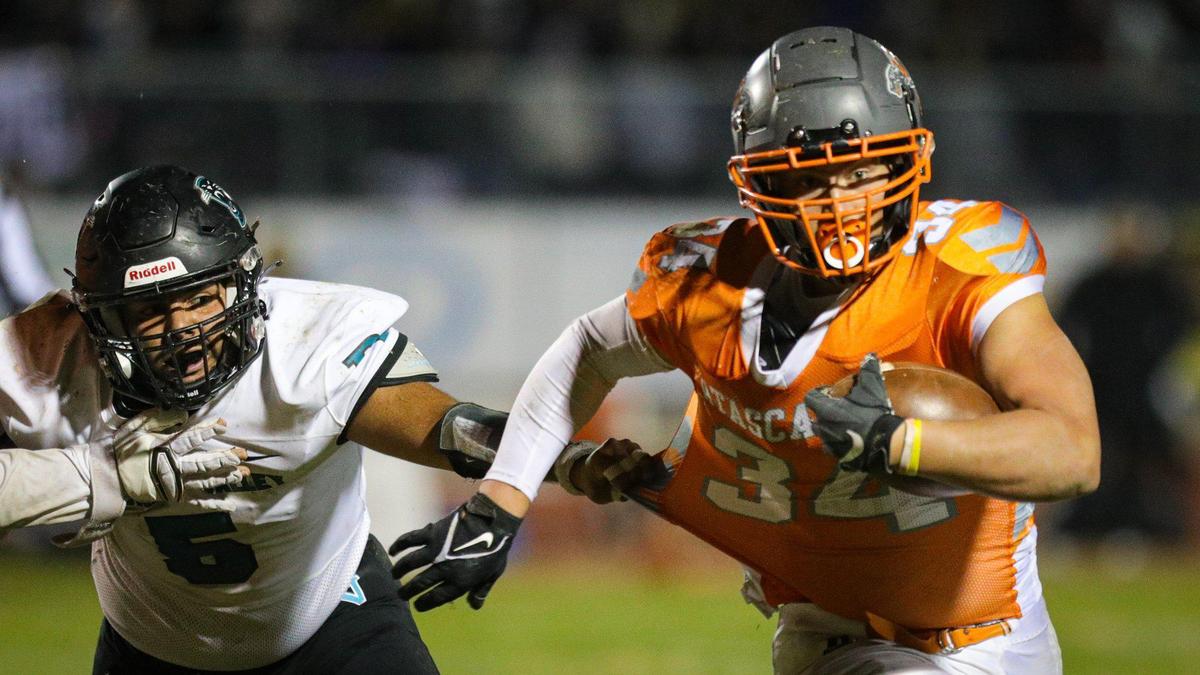 Adrian Mora attempts a shirt tackle of Trey Cooks. Atascadero High School beat Pioneer Valley 27-13 to win the Division V, 2022 CIF Central Section Football Championships Nov. 25, 2022.